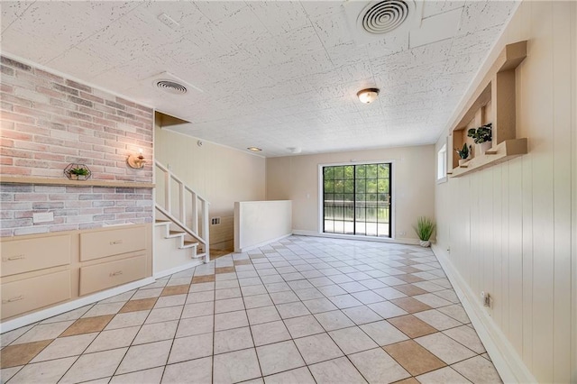 6132 N Eugene Field Rd, Kansas City, MO 64119 - unfurnished room with stairway, baseboards, and light tile patterned floors