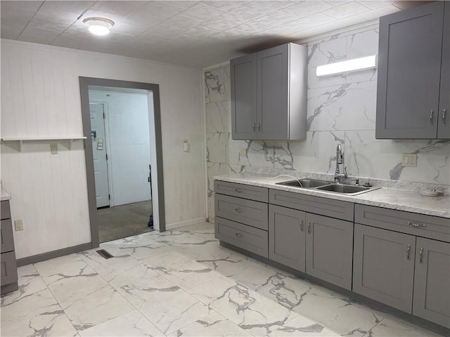 112 N Burns St N, Independence, KS 67301 - kitchen featuring a sink, gray cabinets, light countertops, and wooden walls