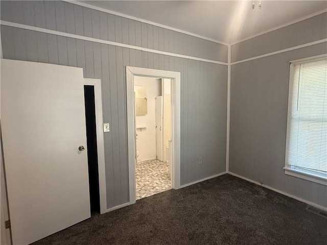 112 N Burns St N, Independence, KS 67301 - empty room with dark colored carpet and healthy amount of natural light