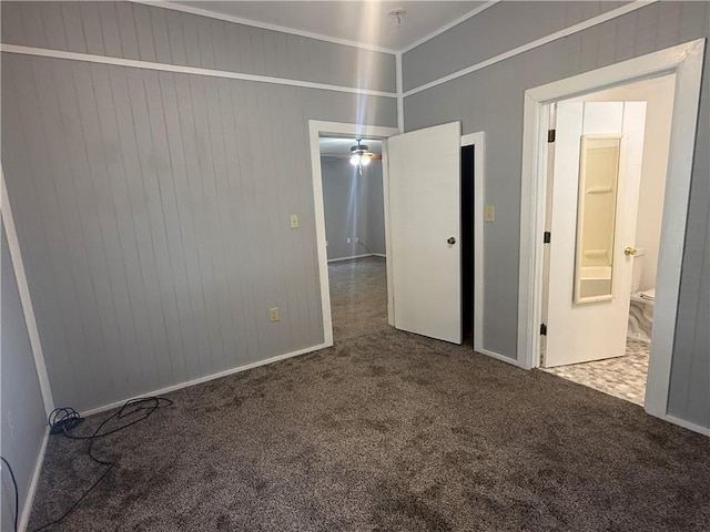 112 N Burns St N, Independence, KS 67301 - carpeted empty room featuring ornamental molding, baseboards, wood walls, and a pendent fire sprinkler