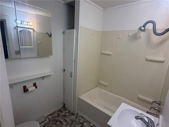 112 N Burns St N, Independence, KS 67301 - bathroom featuring a sink, washtub / shower combination, and baseboards