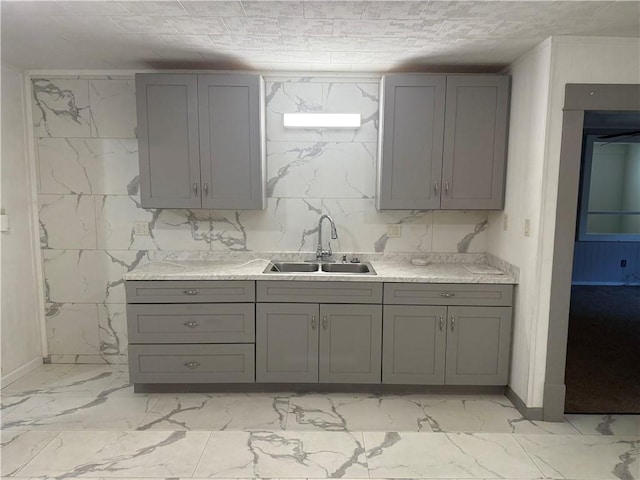 112 N Burns St N, Independence, KS 67301 - kitchen featuring a sink, gray cabinets, light marble finish floors, and light countertops