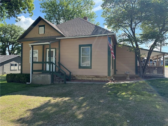 112 N Burns St N, Independence, KS 67301 - view of front of property featuring a chimney, a front lawn, and a shingled roof