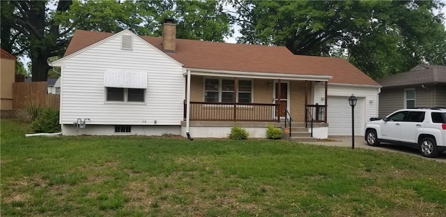 view of front of house with covered porch, a garage, a chimney, and a front yard