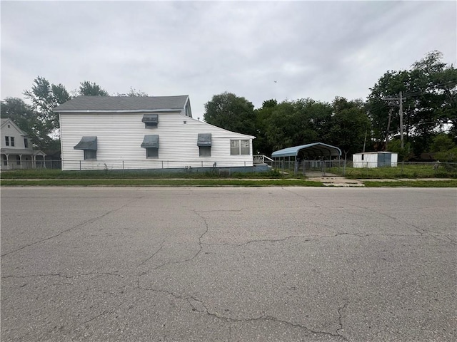 231 Osage St, Leavenworth, KS 66048 - view of side of property with a carport, fence, and driveway