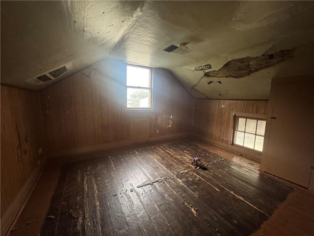 231 Osage St, Leavenworth, KS 66048 - additional living space with hardwood / wood-style floors, lofted ceiling, wooden walls, and baseboards
