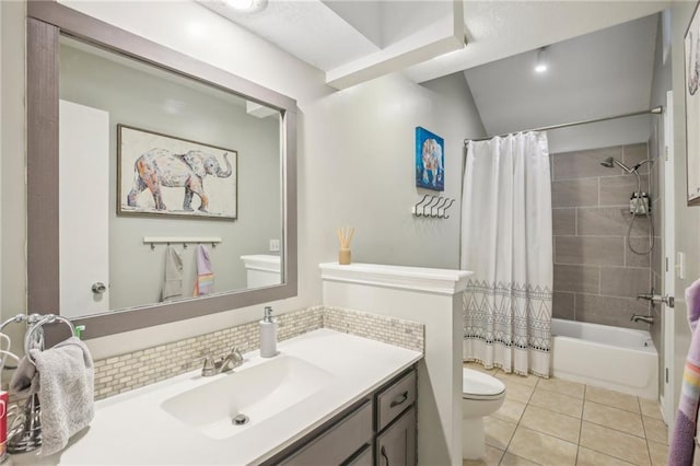 bathroom featuring toilet, tile patterned flooring, tasteful backsplash, shower / tub combo, and vanity