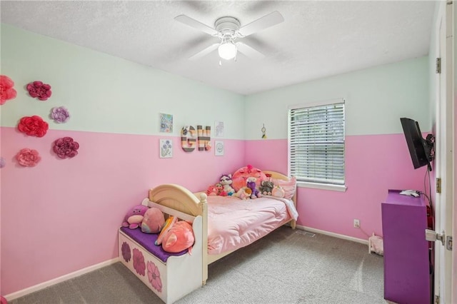 bedroom with carpet, ceiling fan, baseboards, and a textured ceiling