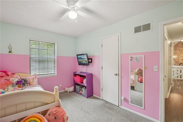 carpeted bedroom with a ceiling fan and baseboards