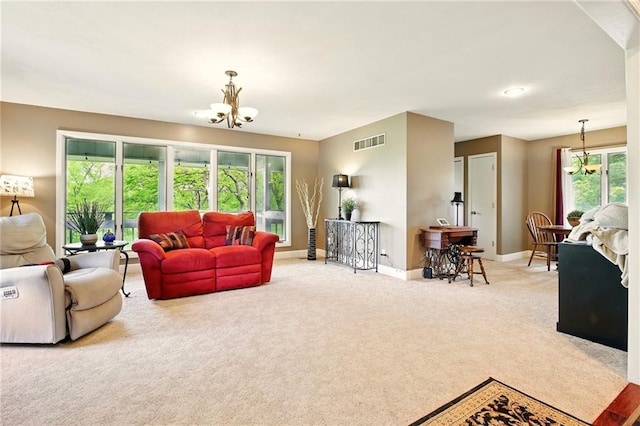 802 High Dr, Excelsior Springs, MO 64024 - carpeted living room featuring baseboards and a chandelier