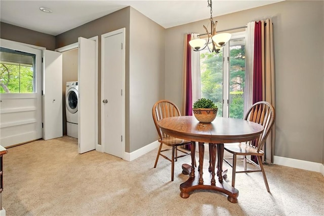 802 High Dr, Excelsior Springs, MO 64024 - dining room featuring light colored carpet, baseboards, washer / clothes dryer, and a chandelier