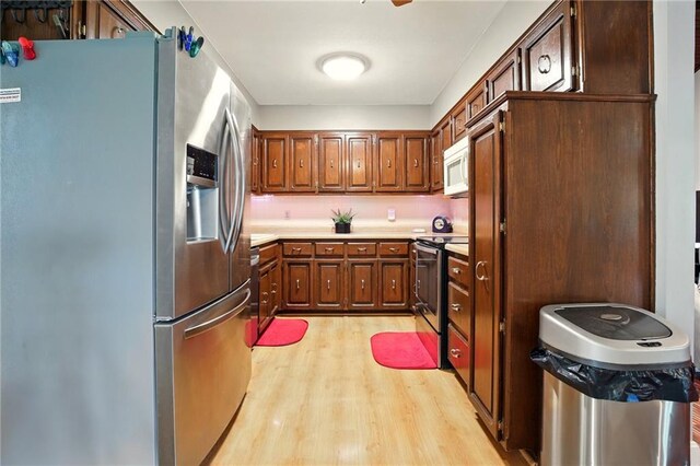 802 High Dr, Excelsior Springs, MO 64024 - kitchen with appliances with stainless steel finishes, light wood-type flooring, and light countertops
