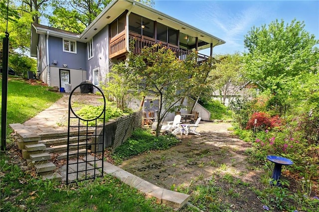 802 High Dr, Excelsior Springs, MO 64024 - rear view of property with ceiling fan, cooling unit, a balcony, and a yard
