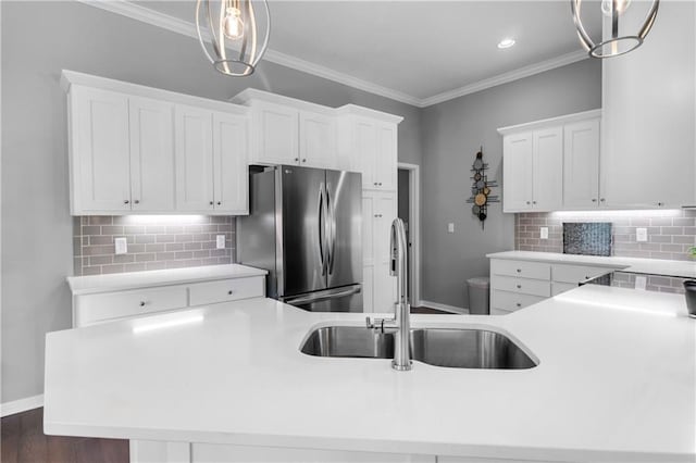 11961 S Tallgrass Dr Unit 403, Olathe, KS 66061 - kitchen with freestanding refrigerator, a sink, decorative backsplash, crown molding, and white cabinets