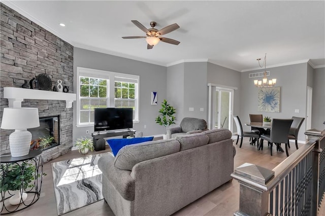 11961 S Tallgrass Dr Unit 403, Olathe, KS 66061 - living room with a chandelier, light wood-type flooring, a fireplace, ceiling fan, and ornamental molding