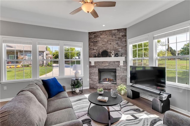 11961 S Tallgrass Dr Unit 403, Olathe, KS 66061 - living area featuring ceiling fan, baseboards, crown molding, a stone fireplace, and wood finished floors