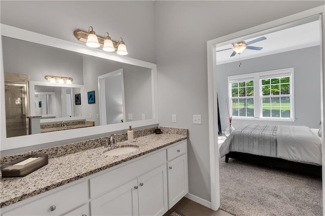 11961 S Tallgrass Dr Unit 403, Olathe, KS 66061 - ensuite bathroom featuring a ceiling fan, vanity, baseboards, a stall shower, and crown molding