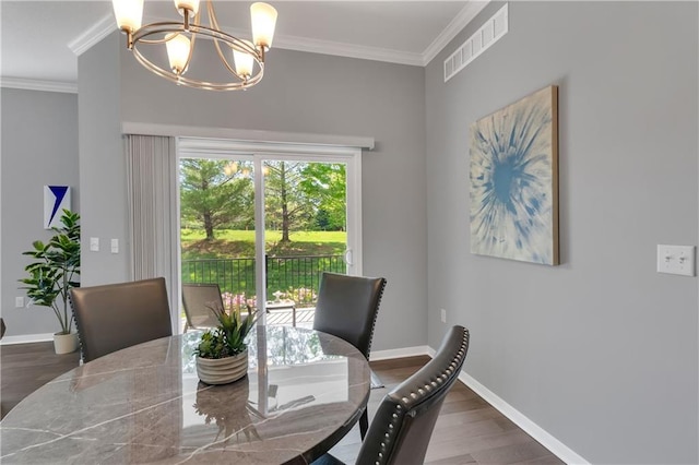 11961 S Tallgrass Dr Unit 403, Olathe, KS 66061 - dining room with a chandelier, wood finished floors, crown molding, and baseboards