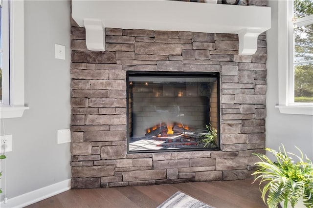 11961 S Tallgrass Dr Unit 403, Olathe, KS 66061 - detailed view of wood finished floors, a stone fireplace, and baseboards