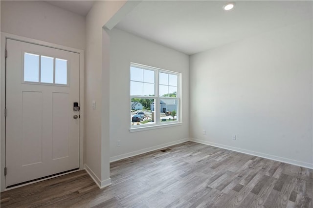 entryway with wood finished floors, baseboards, and recessed lighting
