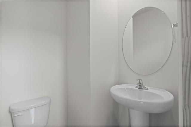 bathroom with toilet and a sink