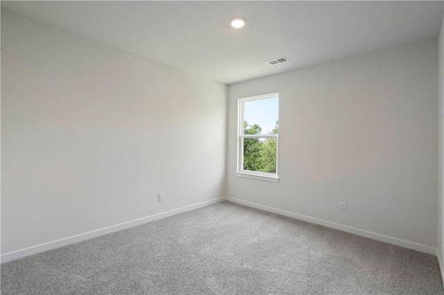 spare room with baseboards, light colored carpet, and recessed lighting