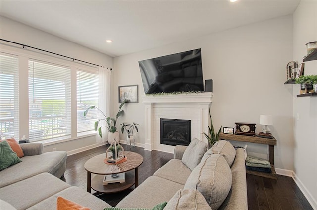 11021 N Oxford Ave, Kansas City, MO 64157 - living room featuring baseboards, recessed lighting, dark wood-style floors, and a glass covered fireplace