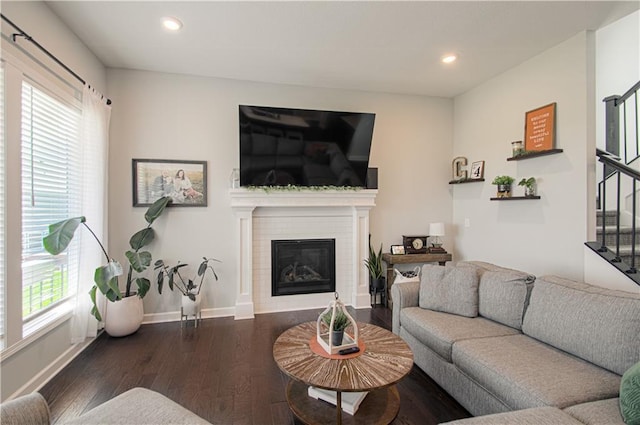 11021 N Oxford Ave, Kansas City, MO 64157 - living room featuring stairs, dark wood-type flooring, recessed lighting, baseboards, and a glass covered fireplace