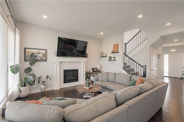 11021 N Oxford Ave, Kansas City, MO 64157 - living area featuring stairs, dark wood-style flooring, a glass covered fireplace, recessed lighting, and baseboards
