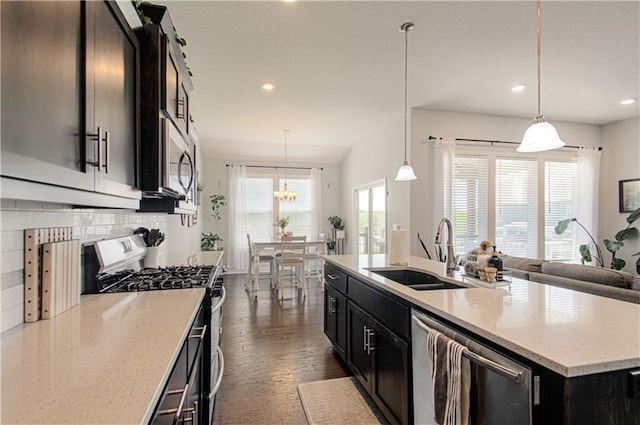11021 N Oxford Ave, Kansas City, MO 64157 - kitchen featuring stainless steel appliances, a sink, recessed lighting, a center island with sink, and light stone counters