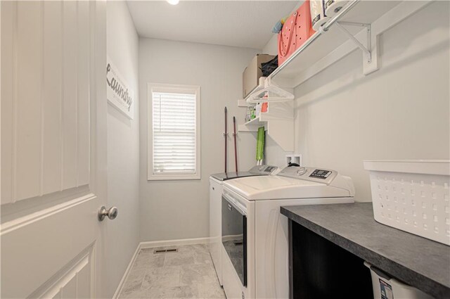 11021 N Oxford Ave, Kansas City, MO 64157 - washroom with washing machine and clothes dryer and baseboards