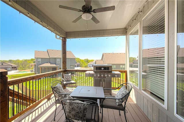 11021 N Oxford Ave, Kansas City, MO 64157 - wooden deck with grilling area, a ceiling fan, a residential view, outdoor dining space, and a yard