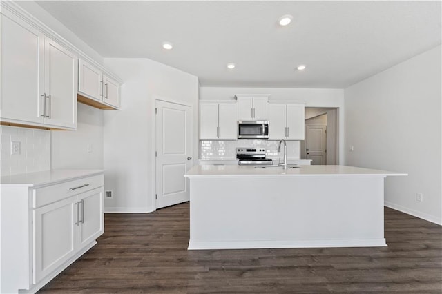 kitchen featuring stainless steel appliances, baseboards, white cabinets, tasteful backsplash, and recessed lighting