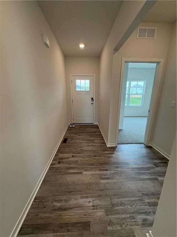 doorway featuring dark wood finished floors, baseboards, and recessed lighting