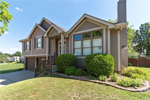 7703 NE 74th Ter, Kansas City, MO 64158 - view of front of house with concrete driveway, an attached garage, and a chimney