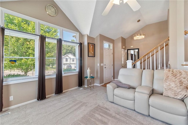 7703 NE 74th Ter, Kansas City, MO 64158 - living area with vaulted ceiling, a chandelier, ceiling fan, and carpet