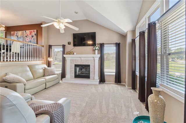7703 NE 74th Ter, Kansas City, MO 64158 - carpeted living room with vaulted ceiling, a ceiling fan, healthy amount of natural light, and a fireplace