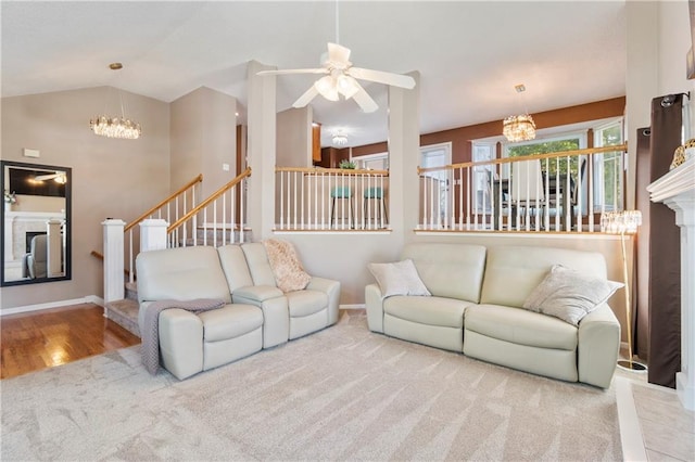 7703 NE 74th Ter, Kansas City, MO 64158 - living room featuring a chandelier, carpet, stairway, ceiling fan, and lofted ceiling