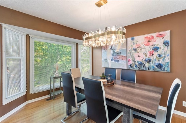 7703 NE 74th Ter, Kansas City, MO 64158 - dining area with wood finished floors and a chandelier