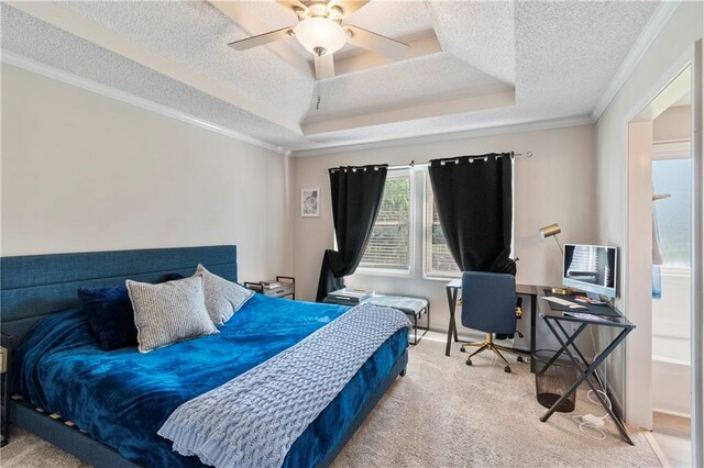 7703 NE 74th Ter, Kansas City, MO 64158 - carpeted bedroom with ornamental molding, a textured ceiling, a tray ceiling, an office area, and a ceiling fan