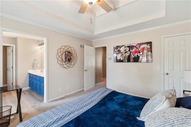 7703 NE 74th Ter, Kansas City, MO 64158 - bedroom with a raised ceiling, light carpet, crown molding, and ensuite bath