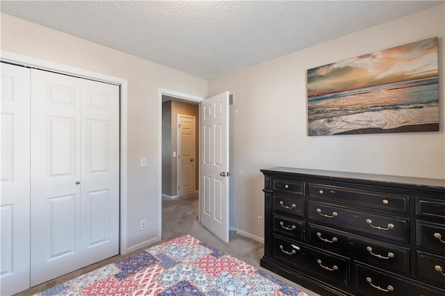 7703 NE 74th Ter, Kansas City, MO 64158 - bedroom with a closet, light carpet, and a textured ceiling