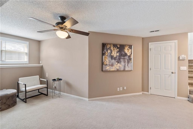 7703 NE 74th Ter, Kansas City, MO 64158 - sitting room featuring a textured ceiling, ceiling fan, and carpet flooring
