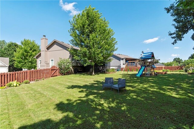 7703 NE 74th Ter, Kansas City, MO 64158 - fenced backyard featuring a playground