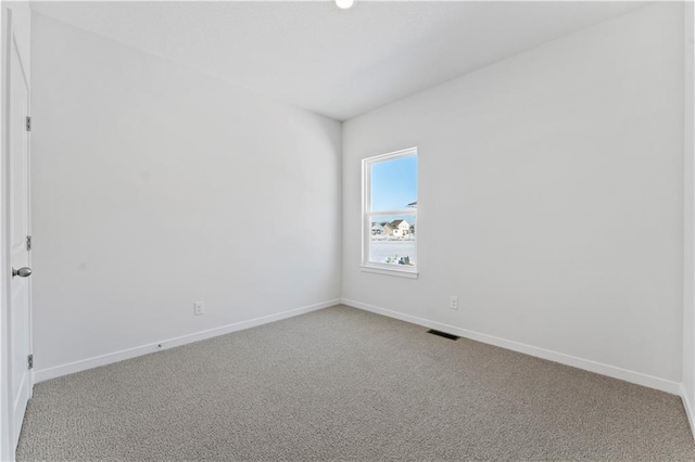 spare room with carpet floors and baseboards