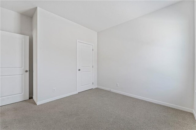 unfurnished bedroom with carpet flooring and baseboards