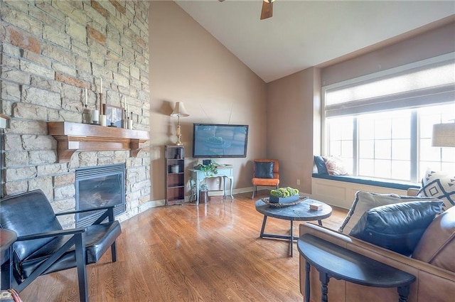 10111 N Tullis Dr, Kansas City, MO 64157 - living area featuring wood finished floors, vaulted ceiling, a fireplace, and baseboards
