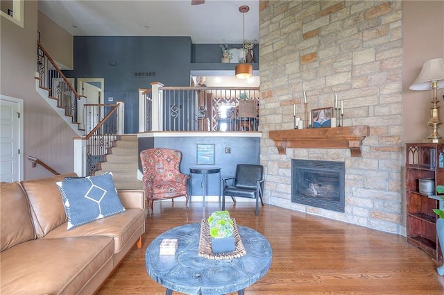 10111 N Tullis Dr, Kansas City, MO 64157 - living room with stairs, wood finished floors, and a stone fireplace