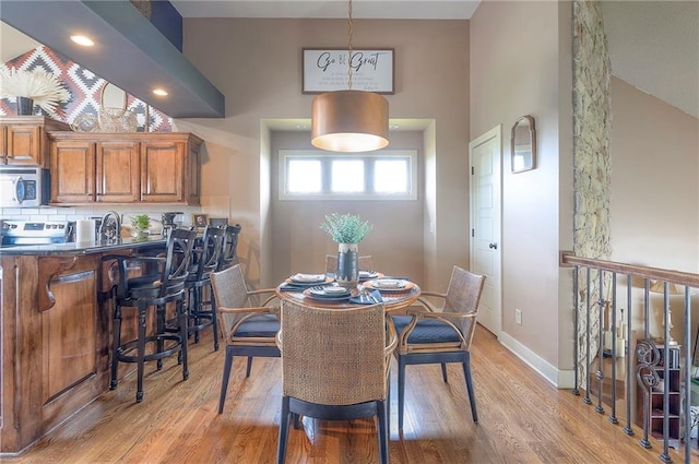 10111 N Tullis Dr, Kansas City, MO 64157 - dining space featuring light wood-type flooring and baseboards