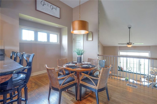 10111 N Tullis Dr, Kansas City, MO 64157 - dining space with wood finished floors, high vaulted ceiling, a ceiling fan, and baseboards